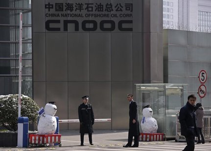 Security personnel stand next to snowmen at the entrance of China National Offshore Oil Corp (CNOOC) office tower in Beijing, March 20, 2013 Security personnel stand next to snowmen at the entrance of China National Offshore Oil Corp (CNOOC) office tower in Beijing, March 20, 2013