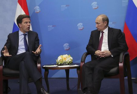 Russia's President Vladimir Putin (R) speaks with Netherlands' Prime Minister Mark Rutte during their meeting at the International Economic Russia's President Vladimir Putin (R) speaks with Netherlands' Prime Minister Mark Rutte during their meeting at the International Economic