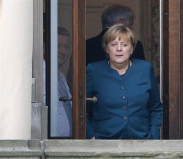 German Chancellor and leader of the Christian Democratic Union (CDU) Angela Merkel stands on a balcony while taking a break during prelimina German Chancellor and leader of the Christian Democratic Union (CDU) Angela Merkel stands on a balcony while taking a break during prelimina