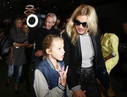 British model Kate Moss leaves the Topshop Unique Spring/Summer 2014 collection with her daughter Lila Grace during London Fashion Week Sept British model Kate Moss leaves the Topshop Unique Spring/Summer 2014 collection with her daughter Lila Grace during London Fashion Week Sept