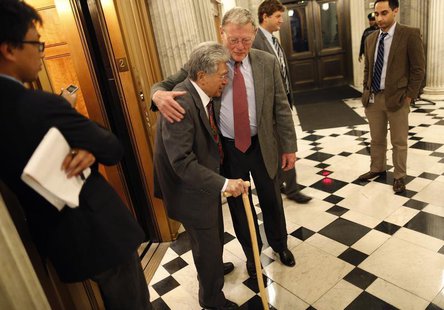 U.S. Senator James Inhofe (R-OK) (C) hugs Senator Daniel Akaka (D-HI) (center L) as they cross paths during a senate vote in the early morni U.S. Senator James Inhofe (R-OK) (C) hugs Senator Daniel Akaka (D-HI) (center L) as they cross paths during a senate vote in the early morni