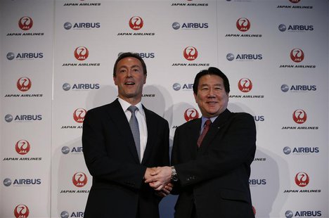 Japan Airlines President Yoshiharu Ueki (R) shakes hands with Airbus Chief Executive Fabrice Bregier during their joint news conference in T Japan Airlines President Yoshiharu Ueki (R) shakes hands with Airbus Chief Executive Fabrice Bregier during their joint news conference in T