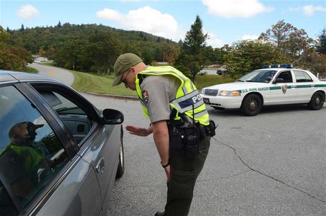 Park Ranger Joseph Darling directs visitors away from the entrance to the Pisgah Inn on the Blue Ridge Parkway southwest of Asheville, North Park Ranger Joseph Darling directs visitors away from the entrance to the Pisgah Inn on the Blue Ridge Parkway southwest of Asheville, North