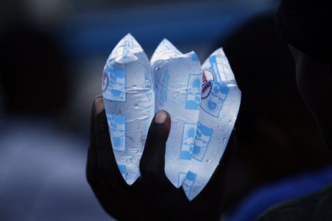 A resident holds packets of water to sell in downtown Port-au-Prince November 23, 2010. REUTERS/ Eduardo Munoz A resident holds packets of water to sell in downtown Port-au-Prince November 23, 2010. REUTERS/ Eduardo Munoz