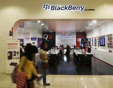 Passers-by walk in front of a BlackBerry service centre in Jakarta September 25, 2013. REUTERS/Beawiharta Passers-by walk in front of a BlackBerry service centre in Jakarta September 25, 2013. REUTERS/Beawiharta