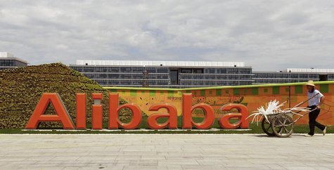 A worker walks past a logo of Alibaba Group at its headquarters on the outskirts of Hangzhou, Zhejiang province, August 24, 2013. REUTERS/Ch A worker walks past a logo of Alibaba Group at its headquarters on the outskirts of Hangzhou, Zhejiang province, August 24, 2013. REUTERS/Ch