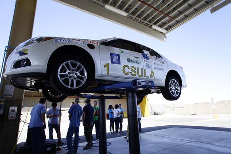 Student engineers from California State University Los Angeles stand by their eco-friendly re-engineered Chevrolet Malibu that was donated b Student engineers from California State University Los Angeles stand by their eco-friendly re-engineered Chevrolet Malibu that was donated b