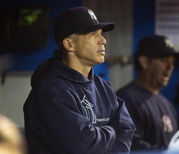 New York Yankees manager Joe Girardi watches from the dugout in the ninth inning of their American League MLB baseball game against the Toro New York Yankees manager Joe Girardi watches from the dugout in the ninth inning of their American League MLB baseball game against the Toro