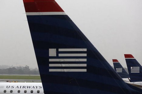 U.S. Airways jets are seen at Reagan National Airport in Washington July 12, 2013. REUTERS/Larry Downing U.S. Airways jets are seen at Reagan National Airport in Washington July 12, 2013. REUTERS/Larry Downing