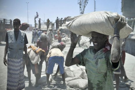 A Somali man carries a bag of cement on his head, after it was unloaded from a ship, at Mogadishu's main port April 15, 2013. REUTERS/Tobin A Somali man carries a bag of cement on his head, after it was unloaded from a ship, at Mogadishu's main port April 15, 2013. REUTERS/Tobin
