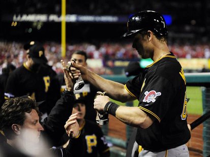 Oct 9, 2013; St. Louis, MO, USA; Pittsburgh Pirates first baseman Justin Morneau (66) celebrates scoring against the St. Louis Cardinals dur Oct 9, 2013; St. Louis, MO, USA; Pittsburgh Pirates first baseman Justin Morneau (66) celebrates scoring against the St. Louis Cardinals dur