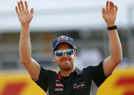 Red Bull Formula One driver Sebastian Vettel of Germany waves to fans at the Suzuka circuit October 10, 2013, ahead of Sunday's Japanese F1 Red Bull Formula One driver Sebastian Vettel of Germany waves to fans at the Suzuka circuit October 10, 2013, ahead of Sunday's Japanese F1