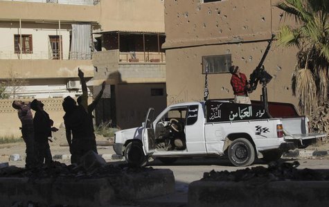 Free Syrian Army fighters point at a MIG fighter jet as one of them aims an anti-aircraft gun towards the sky in Deir al-Zor October 9, 2013 Free Syrian Army fighters point at a MIG fighter jet as one of them aims an anti-aircraft gun towards the sky in Deir al-Zor October 9, 2013