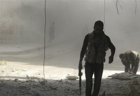 A Free Syrian Army fighter holds his weapon as he walks during what activists said was shelling by forces loyal to Syria's President Bashar A Free Syrian Army fighter holds his weapon as he walks during what activists said was shelling by forces loyal to Syria's President Bashar