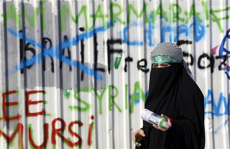 A pro-Palestinian demonstrator stands next to graffiti during an anti-Israeli protest outside the Justice Palace in Istanbul October 10, 201 A pro-Palestinian demonstrator stands next to graffiti during an anti-Israeli protest outside the Justice Palace in Istanbul October 10, 201