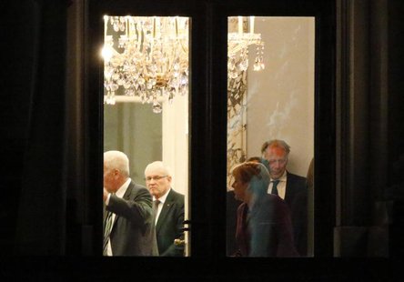 German Chancellor and leader of the Christian Democratic Union (CDU) Angela Merkel (2nd R) stands up at the end of preliminary coalition tal German Chancellor and leader of the Christian Democratic Union (CDU) Angela Merkel (2nd R) stands up at the end of preliminary coalition tal