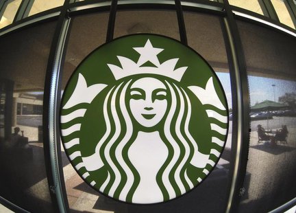 The Starbucks logo hangs on a window inside a newly designed Starbucks coffee shop in Fountain Valley, California August 22, 2013. REUTERS/M The Starbucks logo hangs on a window inside a newly designed Starbucks coffee shop in Fountain Valley, California August 22, 2013. REUTERS/M