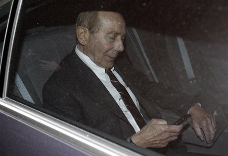 Former CEO of American International Group Inc, Maurice "Hank" Greenberg, checks his phone inside a car after leaving a building in downtown Former CEO of American International Group Inc, Maurice "Hank" Greenberg, checks his phone inside a car after leaving a building in downtown