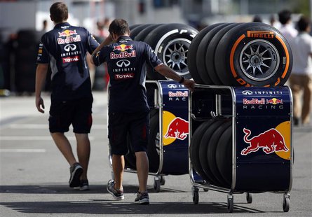Red Bull Formula One team members move Pirelli tires near the pits at the Suzuka circuit in Suzuka October 10, 2013, ahead of Sunday's Japan Red Bull Formula One team members move Pirelli tires near the pits at the Suzuka circuit in Suzuka October 10, 2013, ahead of Sunday's Japan