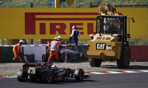 Williams Formula One driver Pastor Maldonado of Venezuela leaves his car during the second practice session of the Japanese F1 Grand Prix at Williams Formula One driver Pastor Maldonado of Venezuela leaves his car during the second practice session of the Japanese F1 Grand Prix at