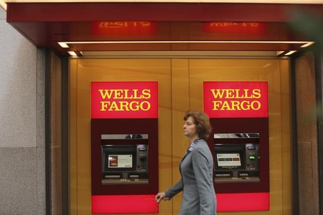 A woman walks past teller machines at a Wells Fargo bank in San Francisco, California October 10, 2013. REUTERS/Robert Galbraith A woman walks past teller machines at a Wells Fargo bank in San Francisco, California October 10, 2013. REUTERS/Robert Galbraith