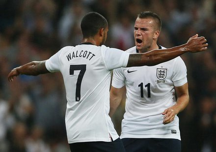 England's Theo Walcott (L) celebrates with team-mate Tom Cleverley after scoring against Scotland during their international friendly soccer England's Theo Walcott (L) celebrates with team-mate Tom Cleverley after scoring against Scotland during their international friendly soccer