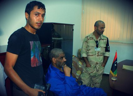 Muammar Gaddafi's former spy chief Abdullah al-Senussi (C) is seen in custody in Tripoli in this undated handout picture. REUTERS/Libyan Nat Muammar Gaddafi's former spy chief Abdullah al-Senussi (C) is seen in custody in Tripoli in this undated handout picture. REUTERS/Libyan Nat