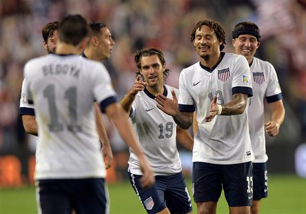 Oct 11, 2013; Kansas City, KS, USA; United States midfielder Graham Zusi (19) celebrates with his teammates after scoring against Jamaica du Oct 11, 2013; Kansas City, KS, USA; United States midfielder Graham Zusi (19) celebrates with his teammates after scoring against Jamaica du