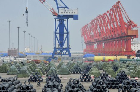 A worker rides his bicycle past piles of steel coils for export at a port in Yingkou, Liaoning province August 9, 2013. REUTERS/Stringer A worker rides his bicycle past piles of steel coils for export at a port in Yingkou, Liaoning province August 9, 2013. REUTERS/Stringer