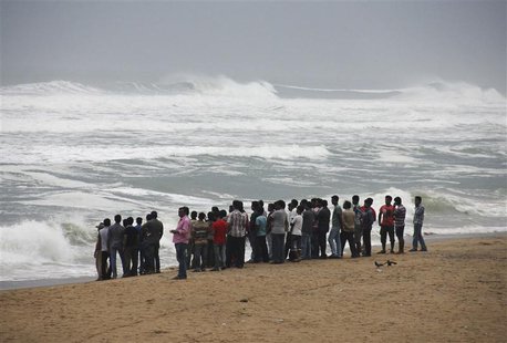 People watch as waves from the Bay of Bengal approach the shore at Podampata village in Ganjam district, in the eastern Indian state of Odis People watch as waves from the Bay of Bengal approach the shore at Podampata village in Ganjam district, in the eastern Indian state of Odis