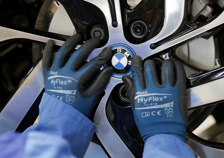 A worker mounts the logo on a rim at the serial production BMW i3 electric car in the BMW factory in Leipzig September 18, 2013. REUTERS/Fab A worker mounts the logo on a rim at the serial production BMW i3 electric car in the BMW factory in Leipzig September 18, 2013. REUTERS/Fab