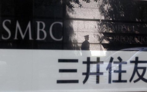 A security guard is reflected on a sign outside a branch of Sumitomo Mitsui Banking Corporation in Tokyo in this July 30, 2012 file photo. R A security guard is reflected on a sign outside a branch of Sumitomo Mitsui Banking Corporation in Tokyo in this July 30, 2012 file photo. R