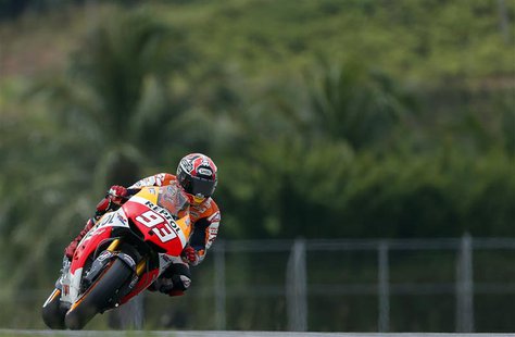 Honda Moto GP rider Marc Marquez of Spain takes a curve during the qualifying session of the Malaysian Motorcycle Grand Prix at Sepang circu Honda Moto GP rider Marc Marquez of Spain takes a curve during the qualifying session of the Malaysian Motorcycle Grand Prix at Sepang circu