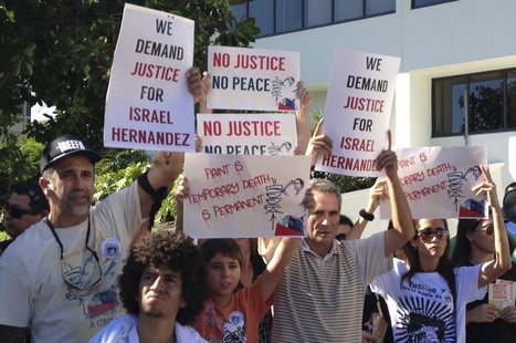 Demonstrators march through Miami Beach October 6, 2013 during a protest over the death of a graffiti artist who died in police custody Augu Demonstrators march through Miami Beach October 6, 2013 during a protest over the death of a graffiti artist who died in police custody Augu