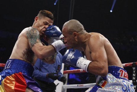 Featherweight boxer Orlando Cruz (L) of Puerto Rico takes a punch from Orlando Salido of Mexico during their title fight at the Thomas and M Featherweight boxer Orlando Cruz (L) of Puerto Rico takes a punch from Orlando Salido of Mexico during their title fight at the Thomas and M