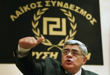 Leader of extreme-right Golden Dawn party Nikolaos Mihaloliakos (C) talks to reporters at a news conference in Athens May 6, 2012. REUTERS/Y Leader of extreme-right Golden Dawn party Nikolaos Mihaloliakos (C) talks to reporters at a news conference in Athens May 6, 2012. REUTERS/Y