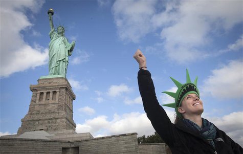 Bethany McNew, 24, from Tampa, mimics the pose of the Statue of Liberty as she poses for a photo on Liberty Island in New York, October 13, Bethany McNew, 24, from Tampa, mimics the pose of the Statue of Liberty as she poses for a photo on Liberty Island in New York, October 13,
