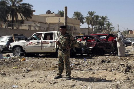 An Iraqi security forces member stands at the site of a car bomb attack in the city of Hilla, 100 km (60 miles) south of Baghdad, October 13 An Iraqi security forces member stands at the site of a car bomb attack in the city of Hilla, 100 km (60 miles) south of Baghdad, October 13