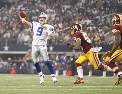 Oct 13, 2013; Arlington, TX, USA; Dallas Cowboys quarterback Tony Romo (9) throws a touchdown pass while being rushed by Washington Redskins Oct 13, 2013; Arlington, TX, USA; Dallas Cowboys quarterback Tony Romo (9) throws a touchdown pass while being rushed by Washington Redskins