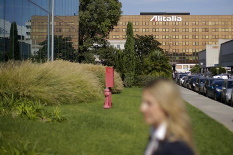 An Alitalia worker walks in front of the headquarter at Fiumicino international airport in Rome October 14, 2013. REUTERS/Max Rossi An Alitalia worker walks in front of the headquarter at Fiumicino international airport in Rome October 14, 2013. REUTERS/Max Rossi
