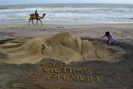 Indian sand artist Sudarshan Pattnaik works on a sand sculpture about Cyclone Phailin that hit Puri in the eastern Indian state of Odisha Oc Indian sand artist Sudarshan Pattnaik works on a sand sculpture about Cyclone Phailin that hit Puri in the eastern Indian state of Odisha Oc