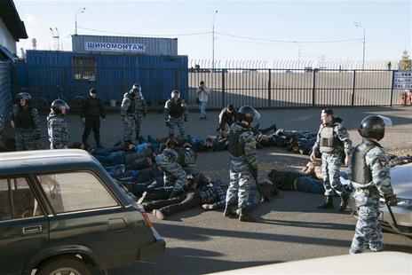 Russian police detain migrant workers during a raid at a vegetable warehouse complex in the Biryulyovo district of Moscow October 14, 2013. Russian police detain migrant workers during a raid at a vegetable warehouse complex in the Biryulyovo district of Moscow October 14, 2013.