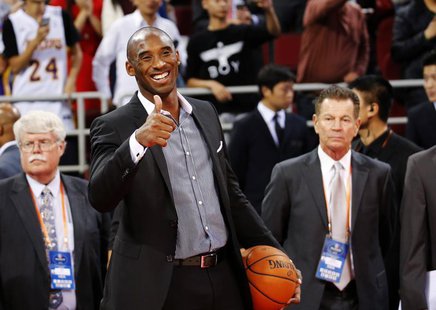 Los Angeles Lakers' Kobe Bryant gestures to his teammates before their game against the Golden State Warriors at the NBA Global Games in Bei Los Angeles Lakers' Kobe Bryant gestures to his teammates before their game against the Golden State Warriors at the NBA Global Games in Bei