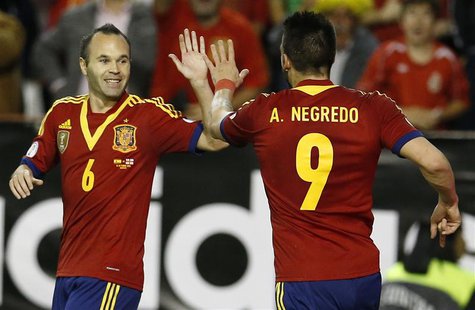 Spain's Alvaro Negredo (R) celebrates his goal with his teammate Andres Iniesta during their 2014 World Cup qualifying soccer match against Spain's Alvaro Negredo (R) celebrates his goal with his teammate Andres Iniesta during their 2014 World Cup qualifying soccer match against
