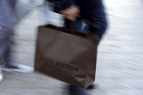 A man walks with a Louis Vuitton shopping bag as he leaves a Louis Vuitton store in Paris September 24, 2013. REUTERS/Philippe Wojazer A man walks with a Louis Vuitton shopping bag as he leaves a Louis Vuitton store in Paris September 24, 2013. REUTERS/Philippe Wojazer