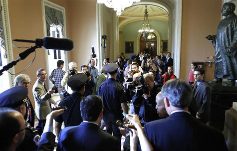 U.S. Senator Ted Cruz (R-TX) (bottom C) is flanked by reporters and police as he departs after a Republican Senate caucus meeting at the U.S U.S. Senator Ted Cruz (R-TX) (bottom C) is flanked by reporters and police as he departs after a Republican Senate caucus meeting at the U.S