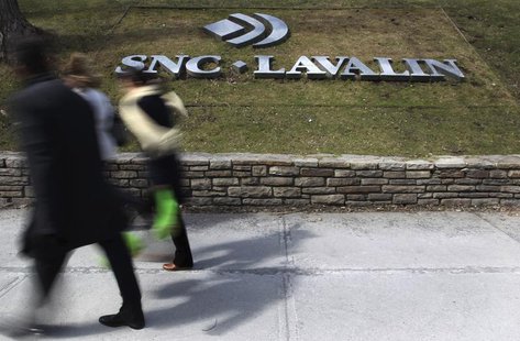 Pedestrians walk past a sign for the head office of SNC Lavalin in downtown Montreal March 26, 2012. REUTERS/Christinne Muschi Pedestrians walk past a sign for the head office of SNC Lavalin in downtown Montreal March 26, 2012. REUTERS/Christinne Muschi