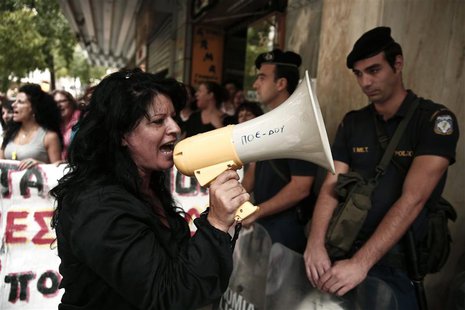 Cleaners working at the finance ministry shout slogans during a rally against job cuts in their sector outside the ministry in Athens Octobe Cleaners working at the finance ministry shout slogans during a rally against job cuts in their sector outside the ministry in Athens Octobe