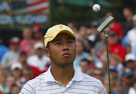 International team player Hideki Matsuyama of Japan flips his ball up after putting on the 14th hole while playing his four ball match with International team player Hideki Matsuyama of Japan flips his ball up after putting on the 14th hole while playing his four ball match with