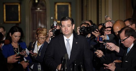 Reporters gather around U.S. Senator Ted Cruz (R-TX), who announces he will not filibuster, as he talks to reporters after a Republican Sena Reporters gather around U.S. Senator Ted Cruz (R-TX), who announces he will not filibuster, as he talks to reporters after a Republican Sena